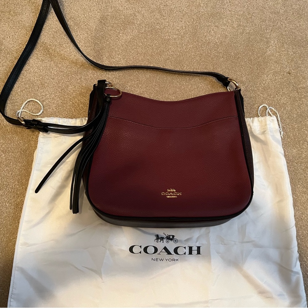 Like New!  Cherry colored Coach crossbody handbag with chestnut trim